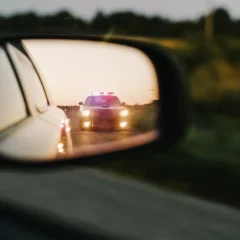 Police car in side mirror reflection - Returning Drivers Courses for drivers on the Gold Coast Qld